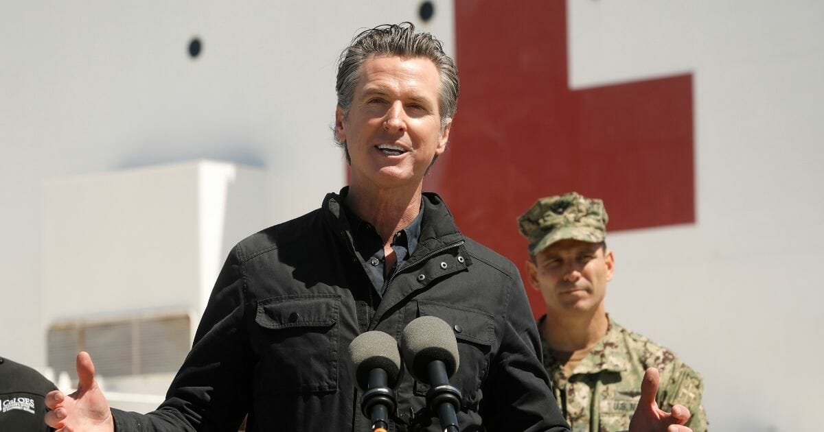 California Gov. Gavin Newsom speaks in front of the hospital ship USNS Mercy that arrived at the Port of Los Angeles on March 27 to provide relief for California hospitals overwhelmed by the coronavirus pandemic.