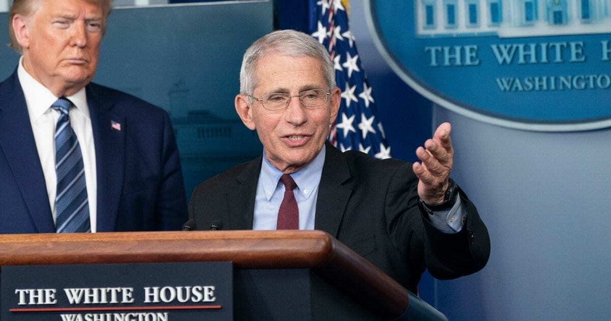 Dr. Anthony Fauci, director of the National Institute of Allergy and Infectious Diseases, speaks alongside President Donald Trump at a White House news briefing Sunday.
