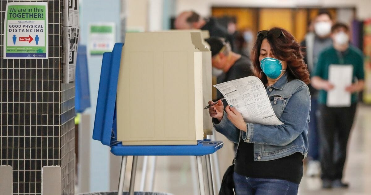 A woman casts her ballot in a Democratic presidential primary election at the Hamilton High School in Milwaukee, Wisconsin, on Tuesday.