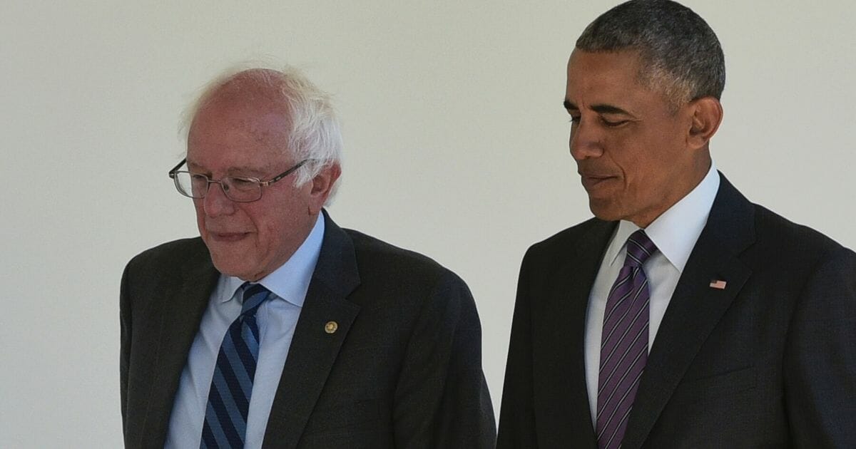 Then-President Barack Obama walks with Vermont Sen. Bernie Sanders at the White House during a 2016 meeting.