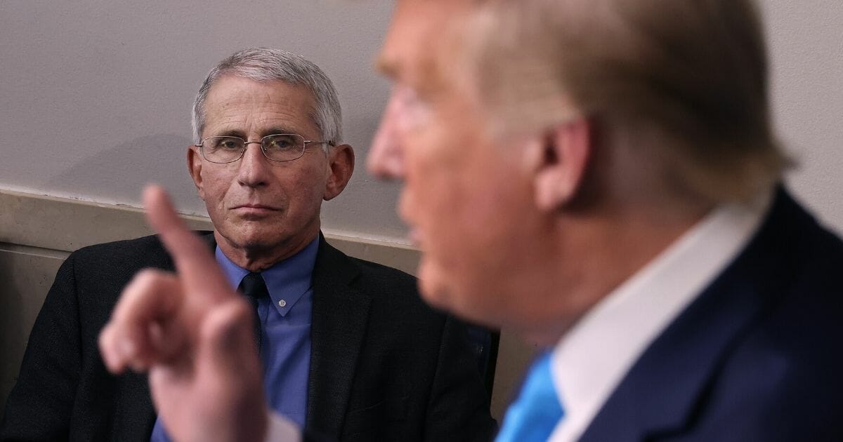 Dr. Anthony Fauci, the director of the National Institute of Allergy and Infectious Diseases, listens to President Donald Trump speak to reporters following a meeting of the coronavirus task force in the Brady Press Briefing Room at the White House on April 7, 2020.