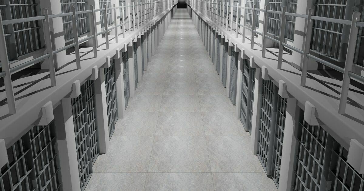 Stock image of a row of prison cells.