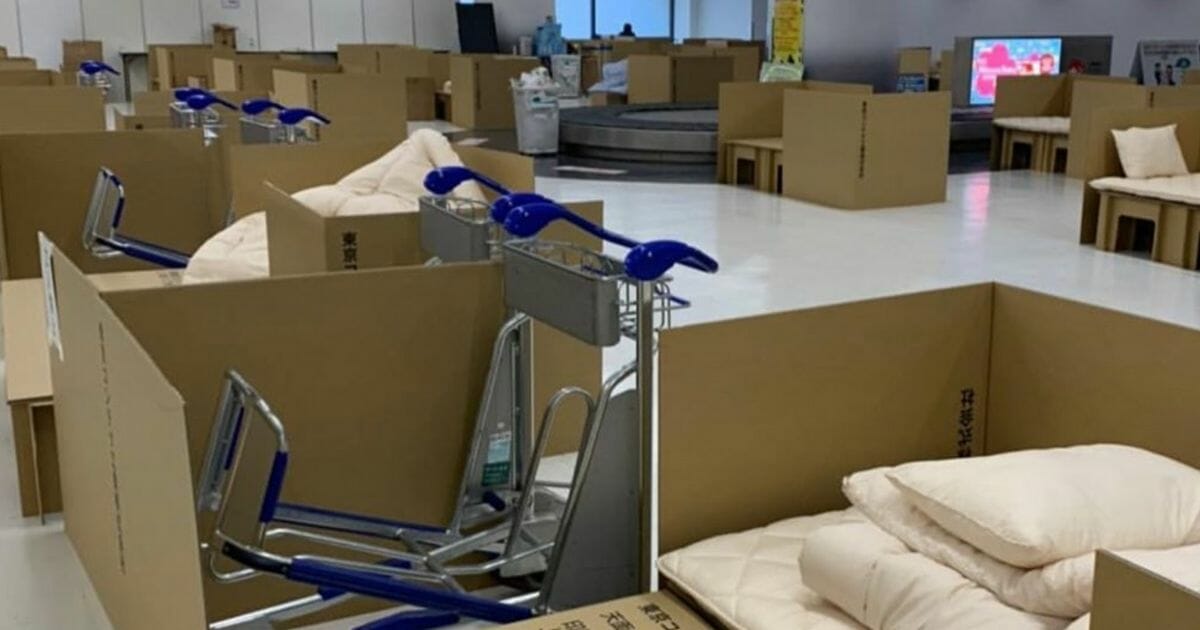 Rows of makeshift cardboard beds crowd Japan’s Narita Airport in Tokyo.