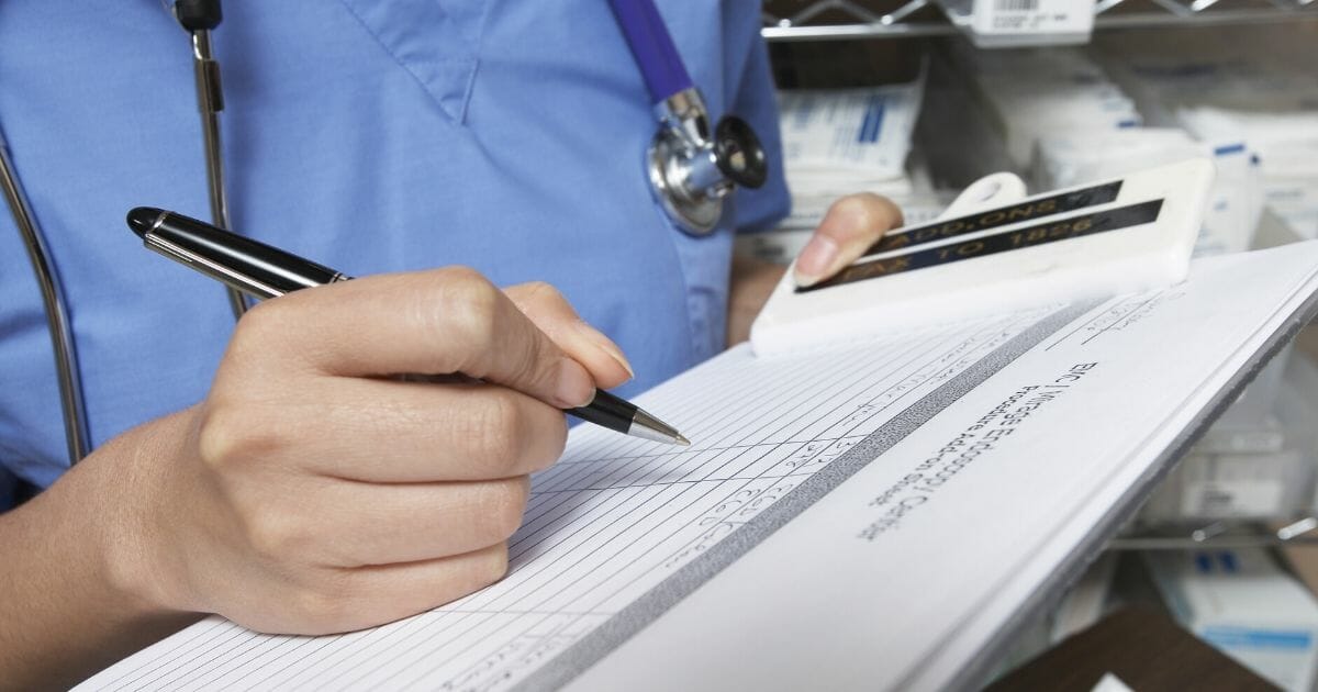 Stock image of a medical professional holding a patient’s chart.