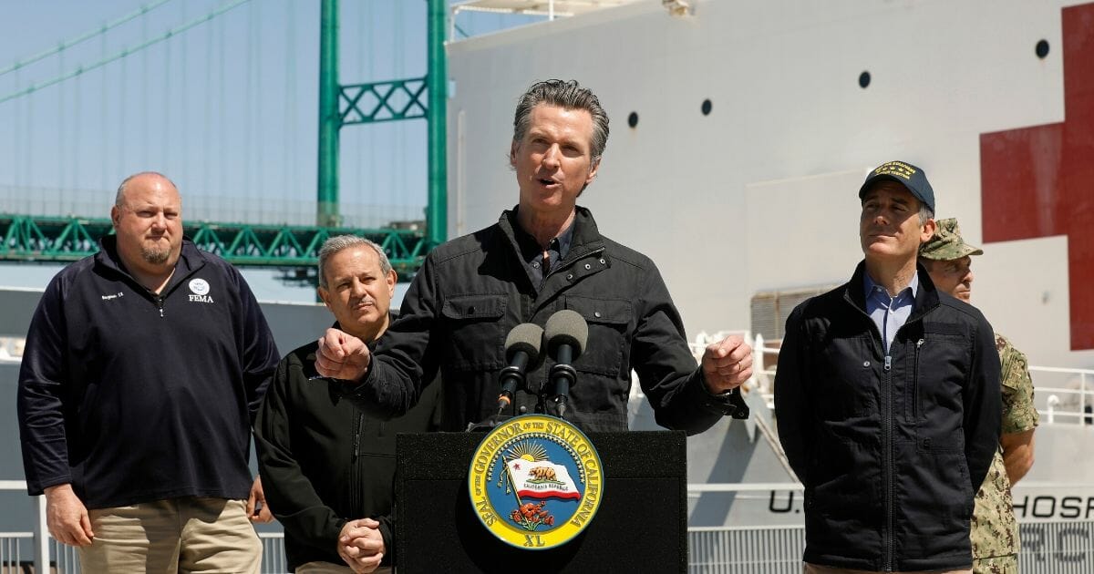 California Gov. Gavin Newsom speaks in front of the hospital ship USNS Mercy that arrived at the Port of Los Angeles on March 27, 2020, to provide relief for Southland hospitals overwhelmed by the coronavirus pandemic.