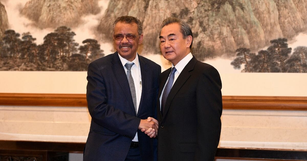 Tedros Adhanom Ghebreyesus, the director-general of the World Health Organization, poses for a photograph with Chinese President Xi Jinping before a meeting at the Great Hall of the People on Jan. 28, 2020, in Beijing.
