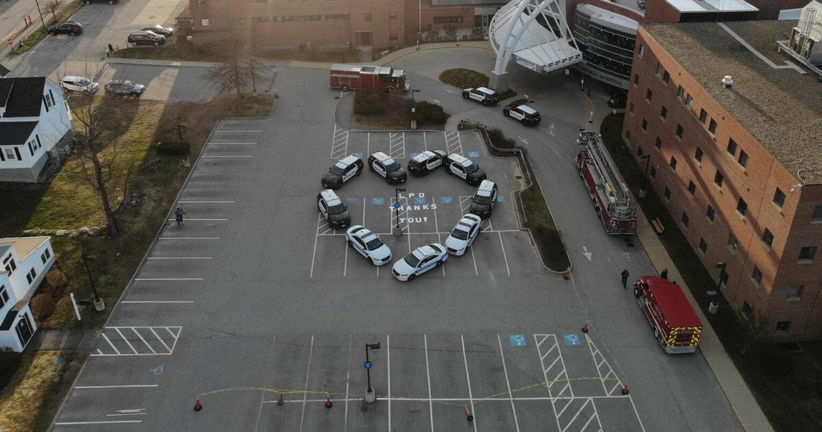 The Laconia Police Department in Laconia, New Hampshire, shows its support for local health care workers with a parking lot display.