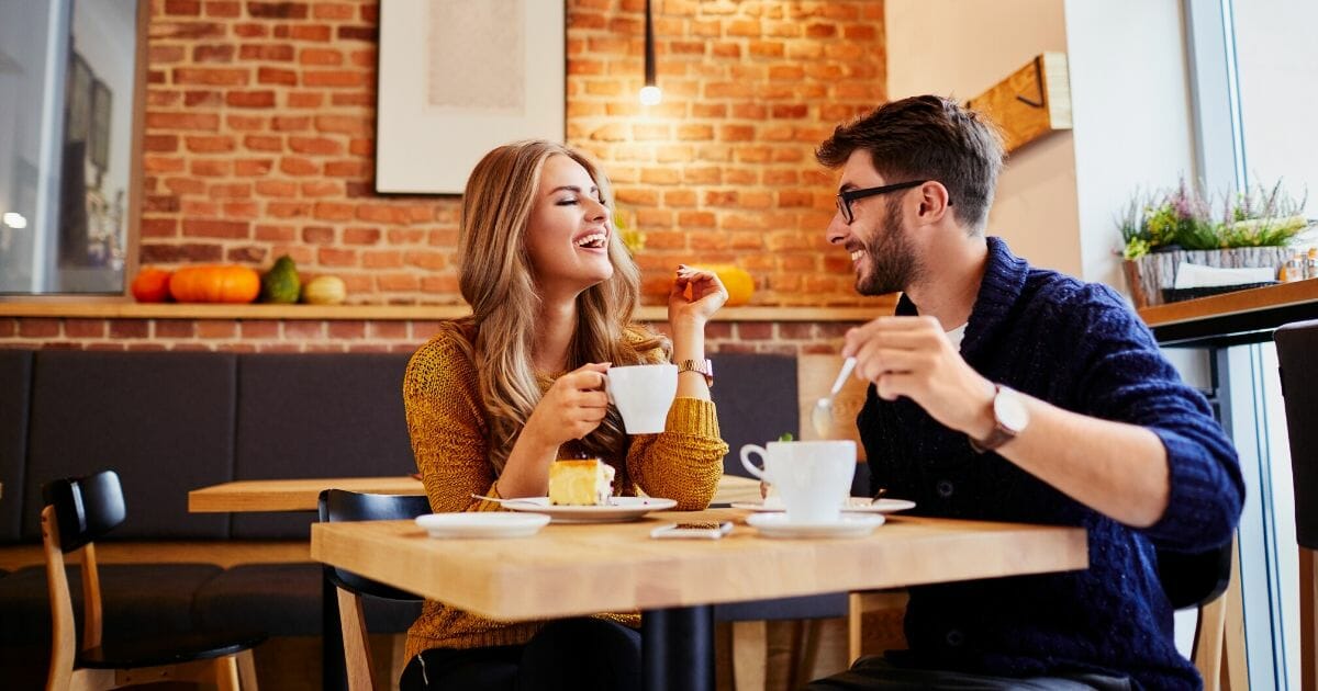 Stock image of a couple on a date in a coffee shop.