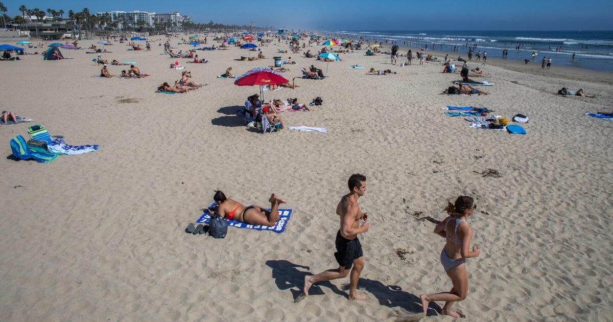 People enjoy the beach amid the coronavirus pandemic in Huntington Beach, California, on April 25, 2020.
