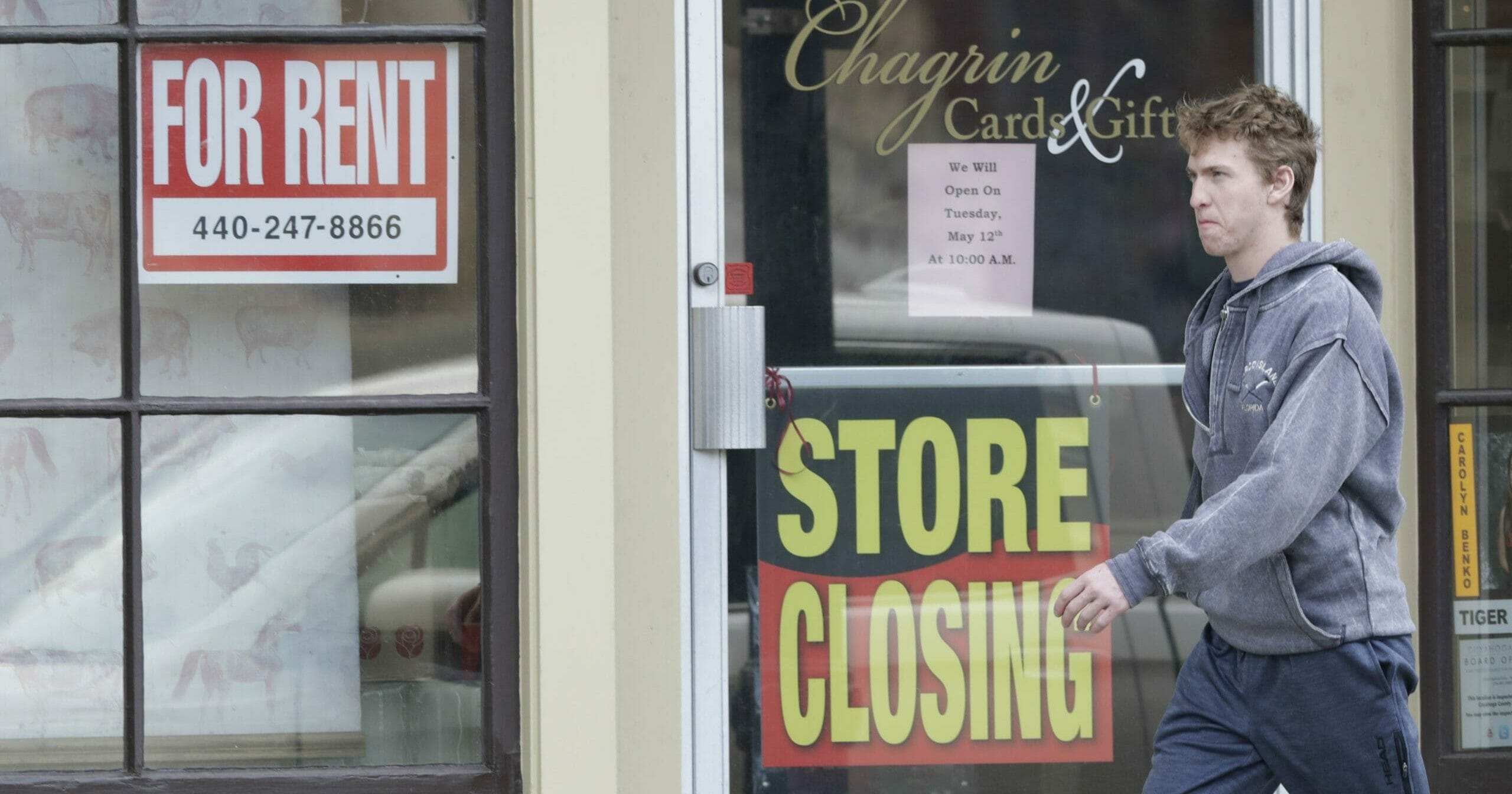 A man walks past a closed business in Chagrin Falls, Ohio, on April 29, 2020.