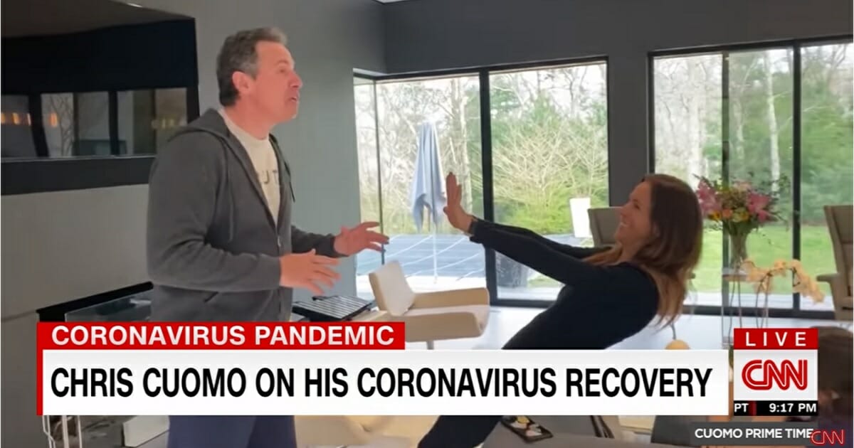 CNN anchor Chris Cuomo and his wife pretend to be reunited after Cuomo's coronavirus self-isolation.