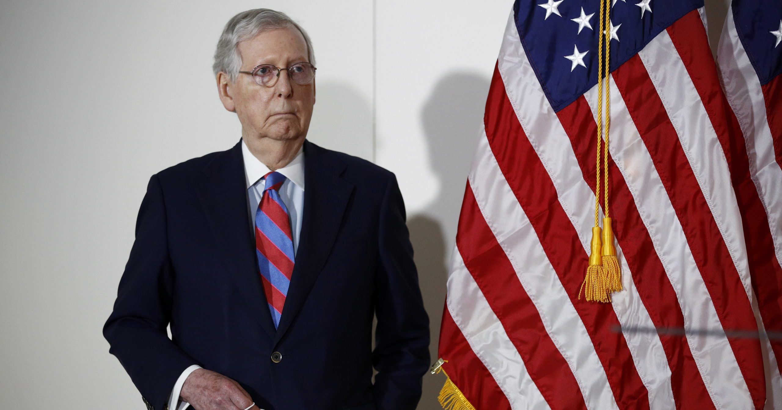 Senate Majority Leader Mitch McConnell of Kentucky holds a face mask used to protect against the spread of the new coronavirus as he attends a news conference on Capitol Hill in Washington on May 12, 2020.