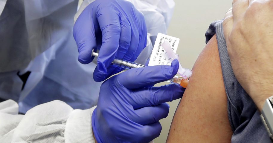 A patient receives a shot in the first-stage safety study clinical trial of a potential vaccine for COVID-1, at the Kaiser Permanente Washington Health Research Institute in Seattle on March 16, 2020.