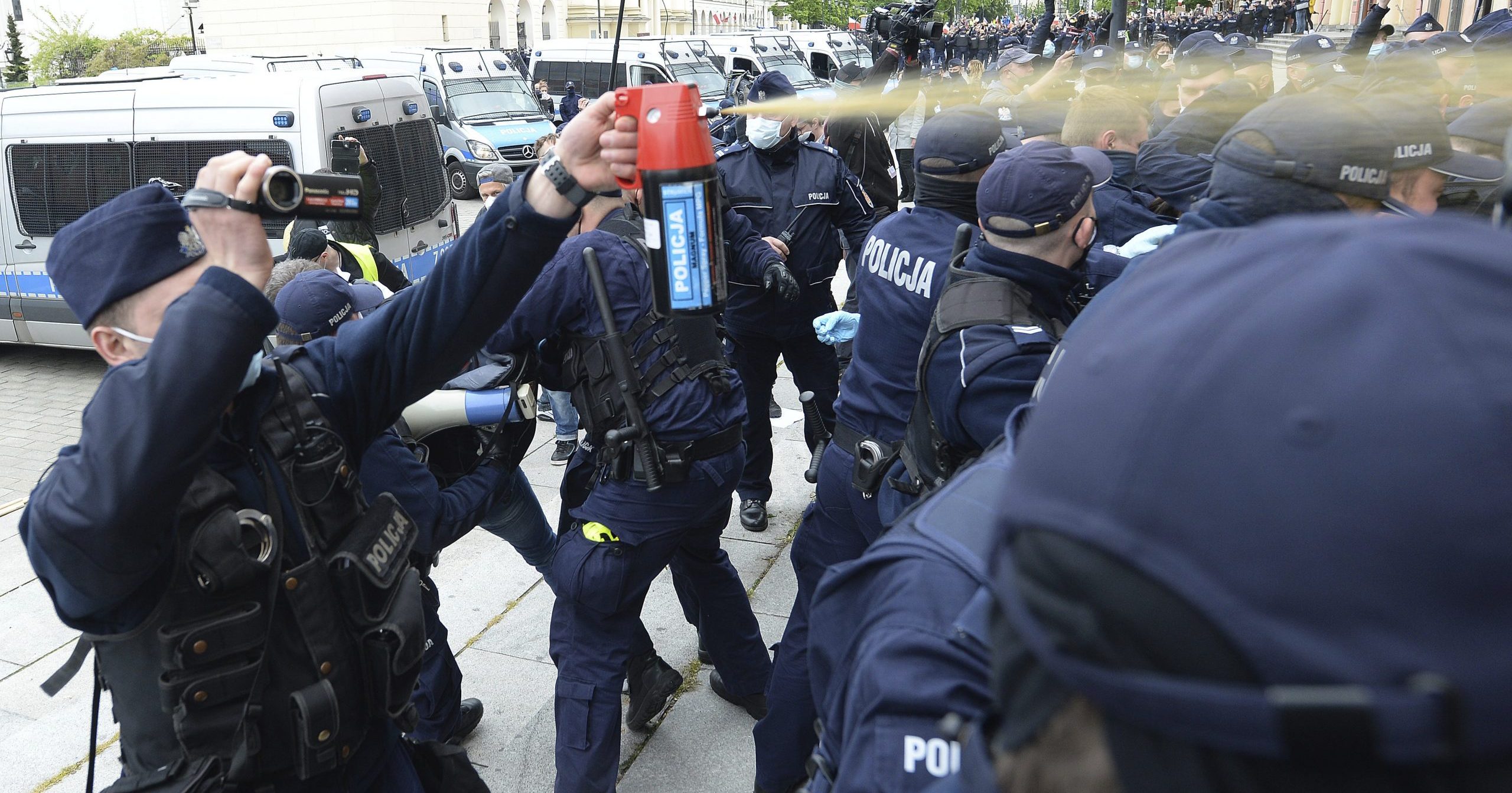 Police fire tear gas toward protesters demanding an end to economic restrictions during the coronavirus pandemic in Warsaw, Poland, on May 16, 2020.