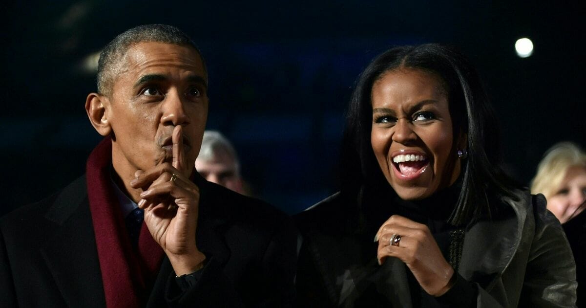 Then-President Barack Obama and then-first lady Michelle Obama react during the National Christmas Tree Lighting on the Ellipse of the National Mall in Washington on Dec. 1, 2016.