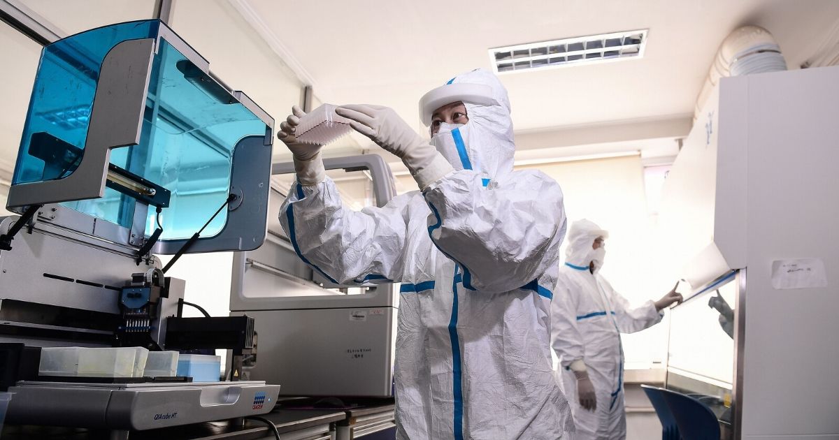 Laboratory technicians work on testing samples at a laboratory in Shenyang in China's northeastern Liaoning province on Feb. 12, 2020.