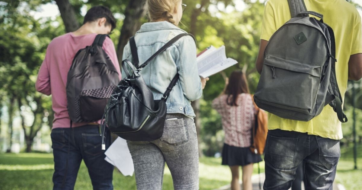 College students walk on campus in the stock photo above.