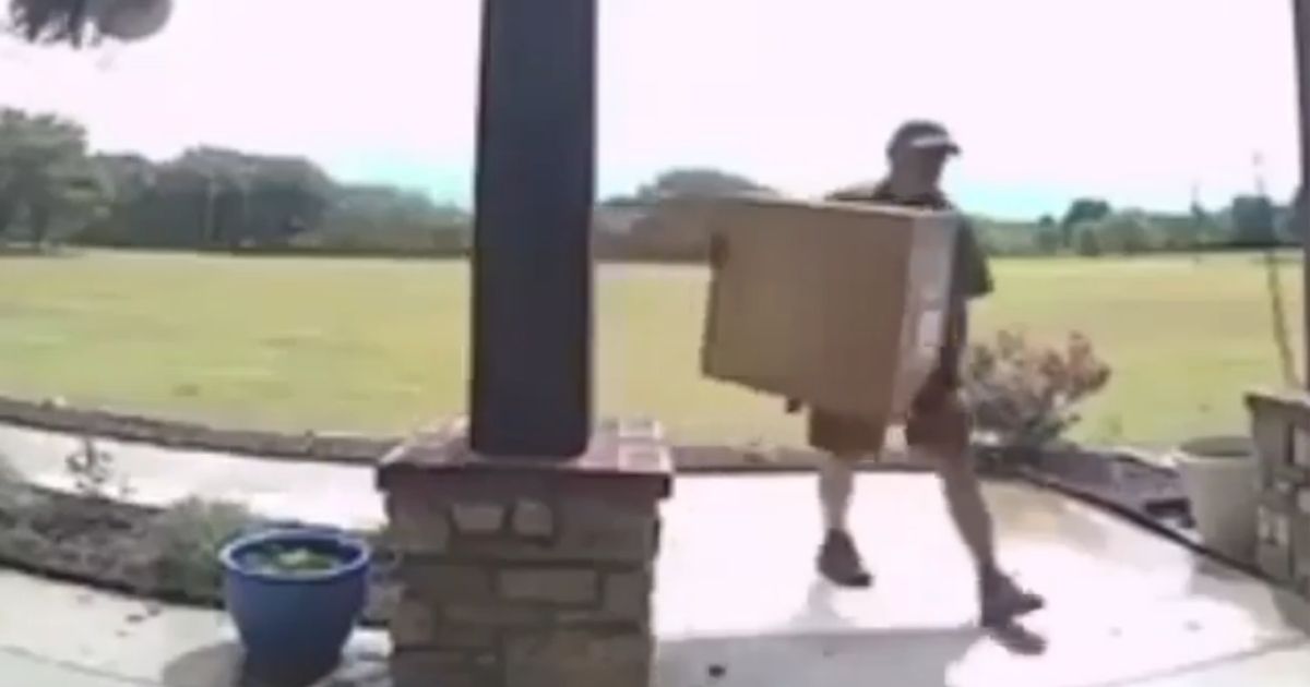 Delivery man carrying a box.