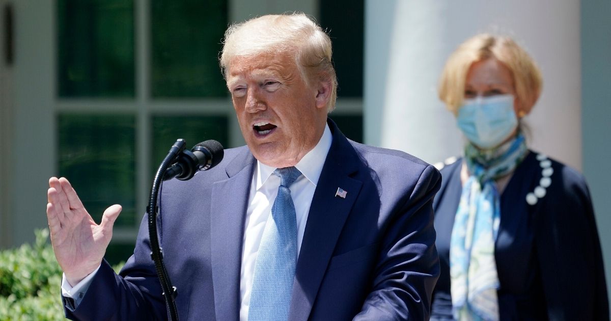 President Donald Trump is joined by Dr. Deborah Brix, White House coronavirus response coordinator, while speaking about coronavirus vaccine development in the Rose Garden of the White House on May 15, 2020, in Washington, D.C.