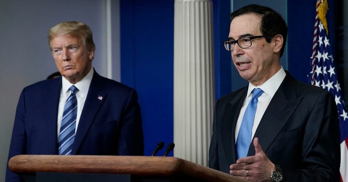 Treasury Secretary Steven Mnuchin, right, speaks as President Donald Trump looks on during the daily coronavirus task force briefing at the White House on April 21, 2020, in Washington, D.C.