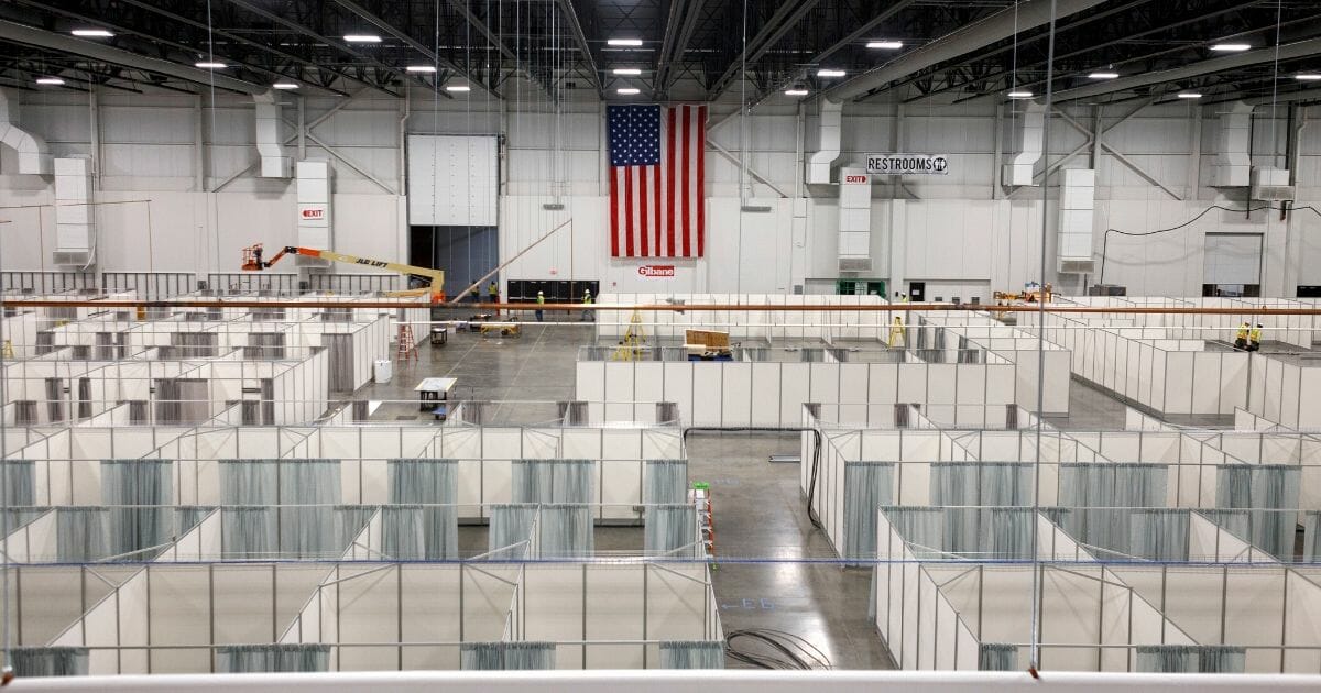 Rows of beds are constructed in a convention hall at Suburban Collection Showplace, which is being converted into a field hospital to treat coronavirus patients, on April 11, 2020, in Novi, Michigan.