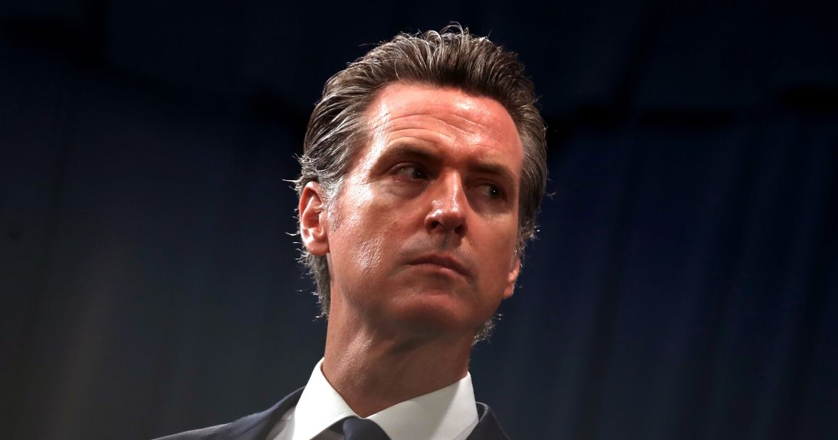 California Gov. Gavin Newsom looks on during a news conference with California Attorney General Xavier Becerra at the California State Capitol on Aug. 16, 2019, in Sacramento, California.