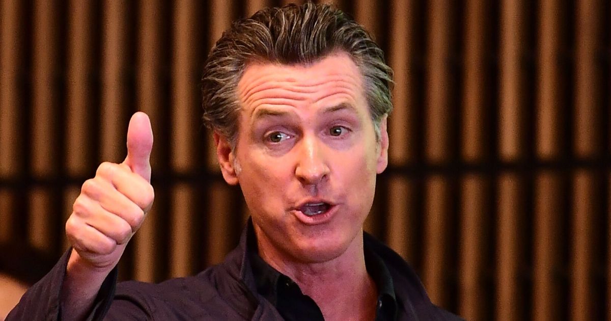 California Gov. Gavin Newsom gives a thumbs up during a visit to East Los Angeles College in Monterey Park on Aug. 29, 2019.