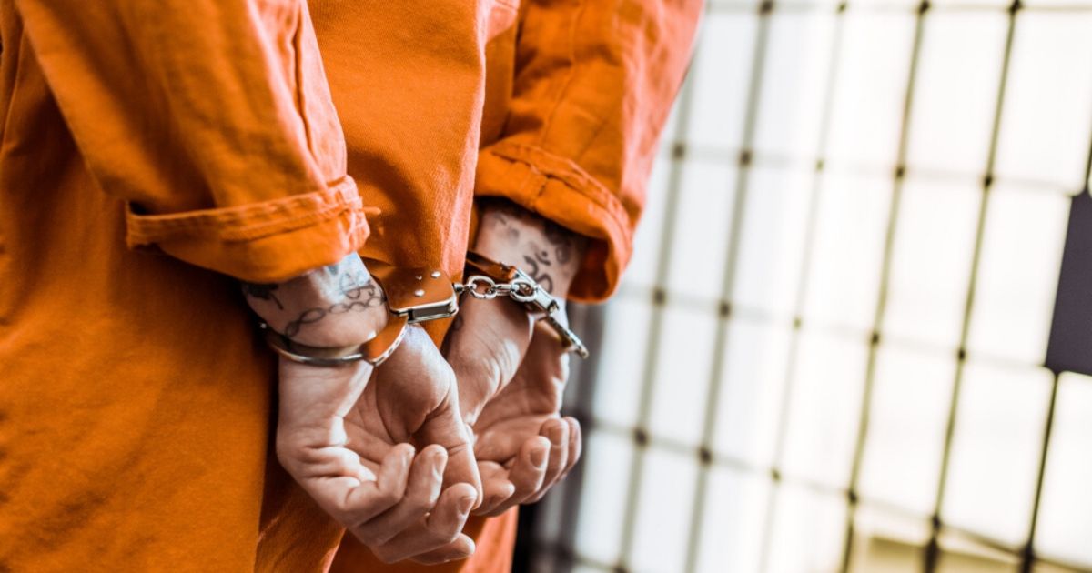 A stock photo of an inmate is seen above.