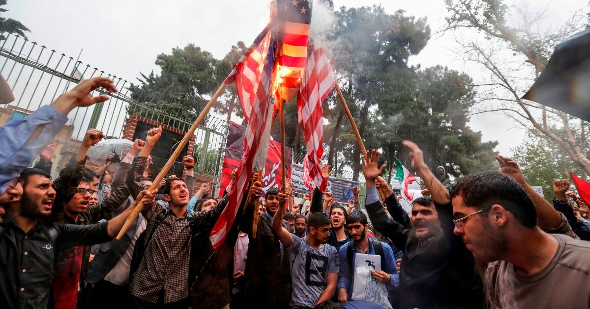 Iranians burn U.S. flags during an anti-U.S. demonstration outside the former U.S. embassy headquarters in the capital city of Tehran on May 9, 2018.