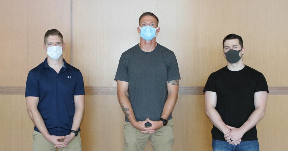 Three Marines are being hailed as heroes after they stepped in when a passenger on a flight bound from Japan to the United States became disruptive and threatening.
