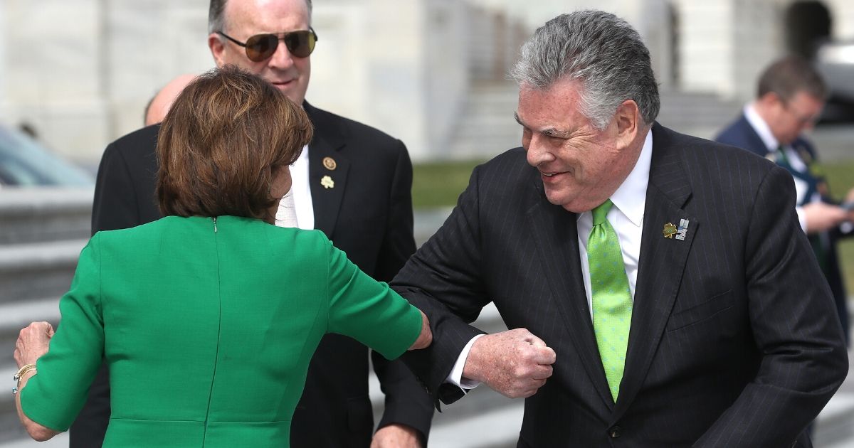 House Speaker Nancy Pelosi, D-Calif., touches elbows with Rep. Peter King, R-N.Y., after the annual Friends of Ireland luncheon at the Rayburn Room of U.S. Capitol on March 12, 2020.