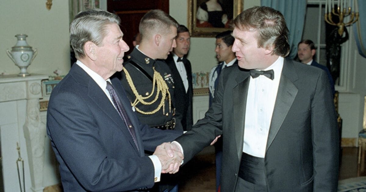 President Ronald Reagan shakes the hand of Donald Trump.