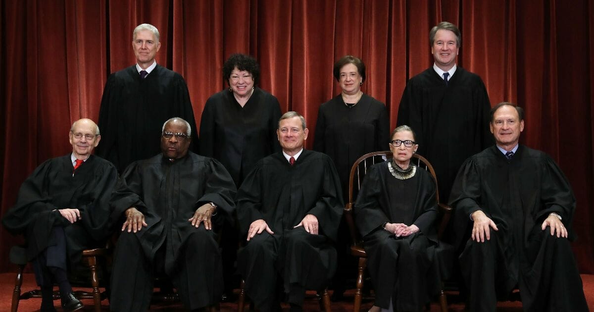 The nine Supreme Court justices pose for their official photo in the image above.