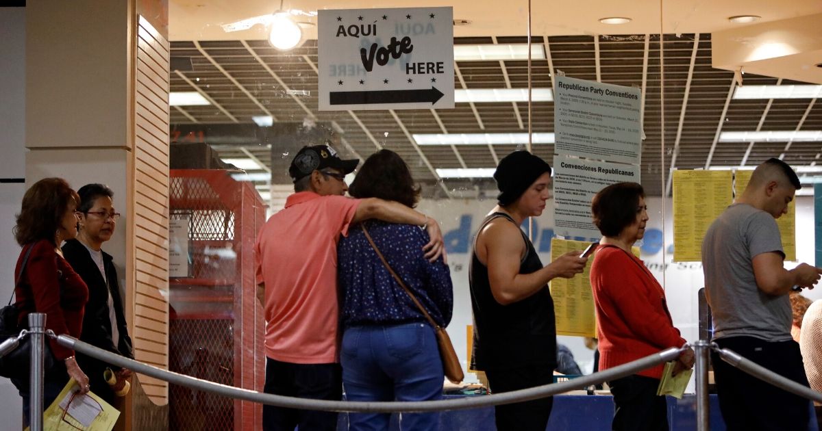 Texas voters wait in line to cast their ballots