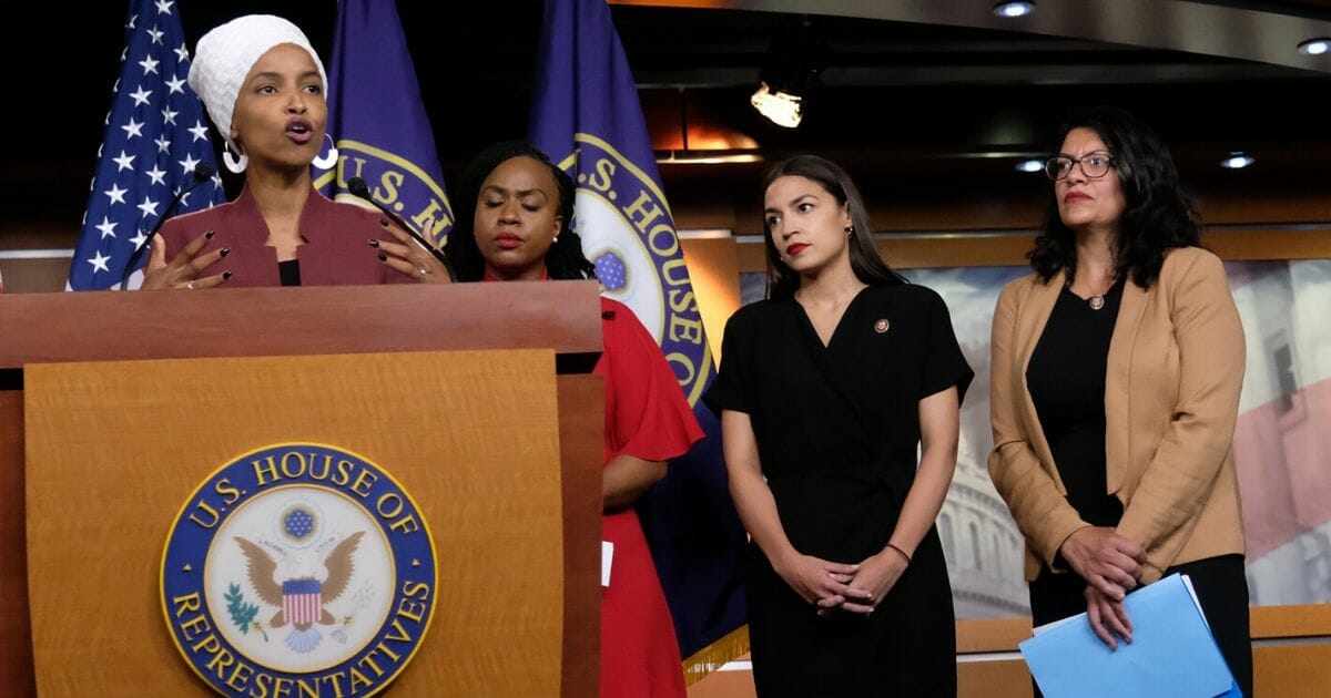 From left to right, Rep. Ilhan Omar (D-Minnesota) speaks as Reps. Ayanna Pressley (D-Massachusetts), Alexandria Ocasio-Cortez (D-New York), and Rashida Tlaib (D-Michigan) listen during a news conference at the U.S. Capitol on July 15, 2019, in Washington, D.C.