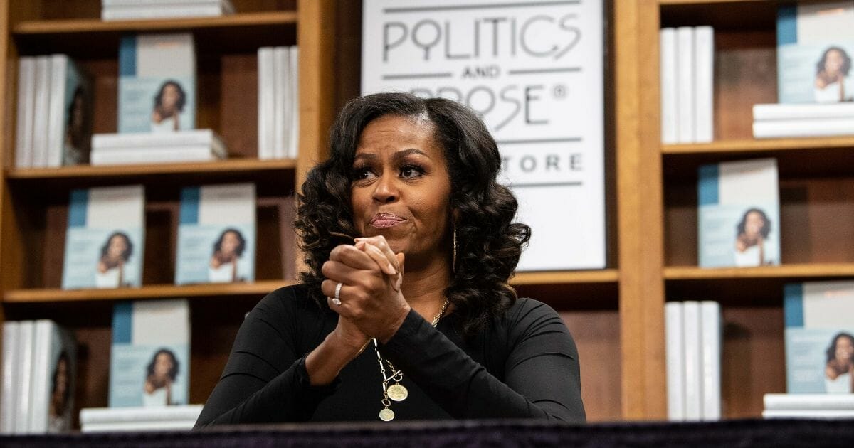 Former first lady Michelle Obama meets with fans during a book signing on the first anniversary of the launch of her memoir "Becoming" at the Politics and Prose bookstore in Washington, D.C., on Nov. 18, 2019.