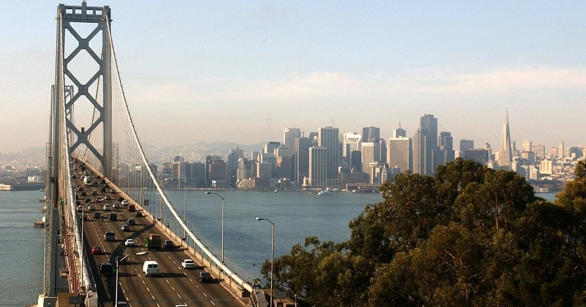A view of San Franciso with the Bay Bridge in the foreground.