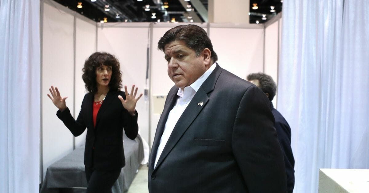 Illinois Gov. J.B. Pritzker tours a temporary field hospital set up in Chicago's McCormick Place convention center on April 3.