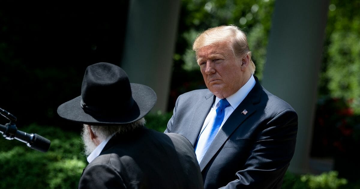 President Donald Trump watches as Rabbi Yisroel Goldstein speaks during a National Day of Prayer service in the White House Rose Garden on May 2.