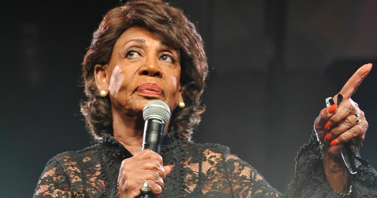 U.S. Rep. Maxine Waters holds a microphone in a file photo from the Beautycon Festival Los Angeles in 2019.
