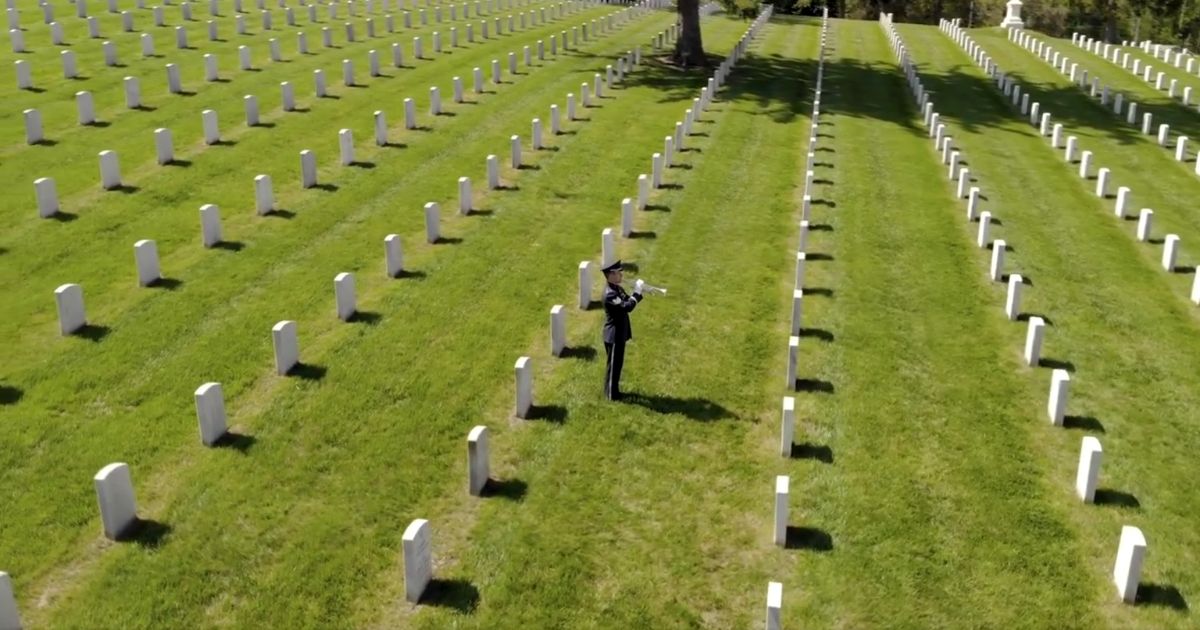 Technical Sgt. Jason Covey of the Air Force plays "Taps" at Culpepper National Cemetery in Culpepper, Virginia.