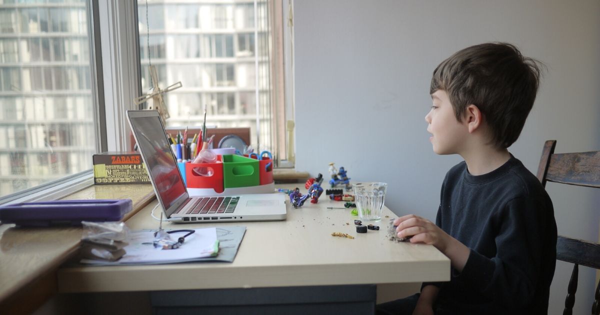 A young boy participates in an online lesson for his kindergarten class while schools remain closed to help slow the spread of COVID-19 in Chicago on April 3, 2020.