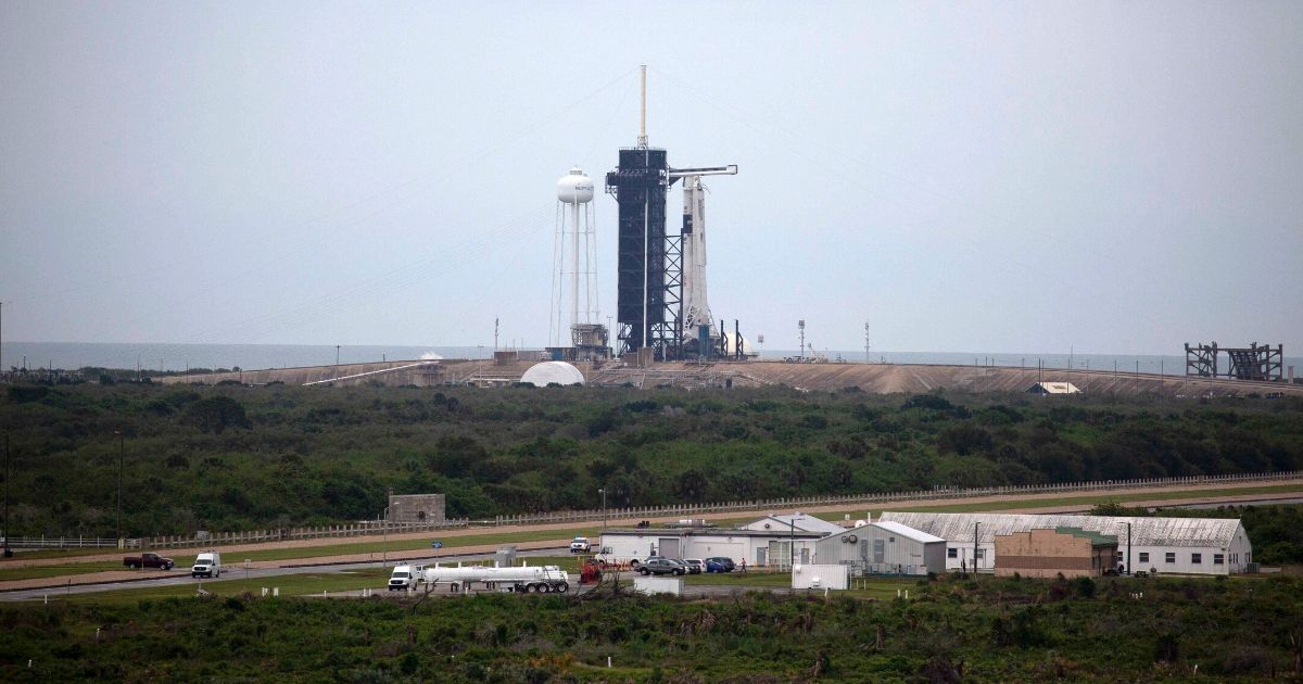 The SpaceX Falcon 9 rocket with the manned Crew Dragon spacecraft sits on launch pad 39A at the Kennedy Space Center on May 27, 2020, in Cape Canaveral, Florida. NASA astronauts Bob Behnken and Doug Hurley were scheduled to be the first people since the end of the Space Shuttle program in 2011 to be launched into space from the United States, but the launch was postponed due to bad weather.