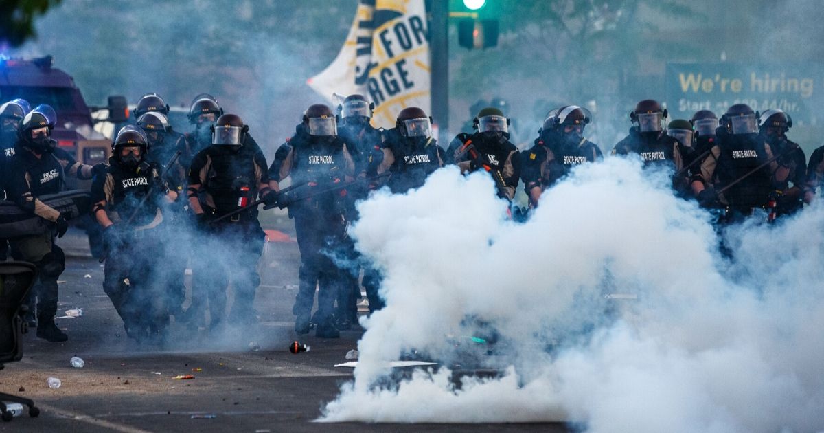 Minneapolis police in riot gear prepare to confront rioters Saturday as looting continues after "protests" of a man in police custody on Monday.