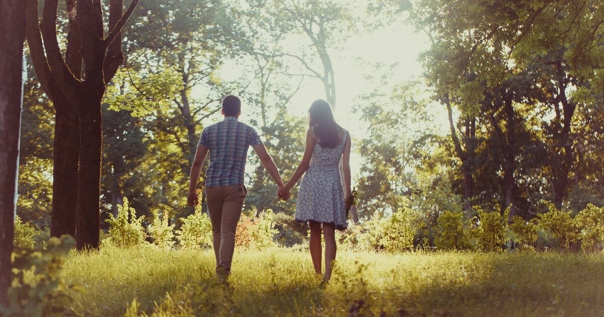 Stock image of a couple walking in the park.