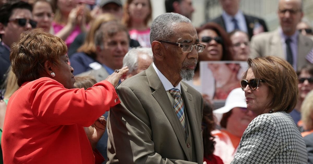 Democratic Rep. Bobby Rush of Illinois, center, is comforted by then-House Minority Leader Nancy Pelosi and Democratic Rep. Brenda Lawrence of Michigan, left, after he spoke during a news conference on gun control on June 22, 2016, on Capitol Hill in Washington, D.C.