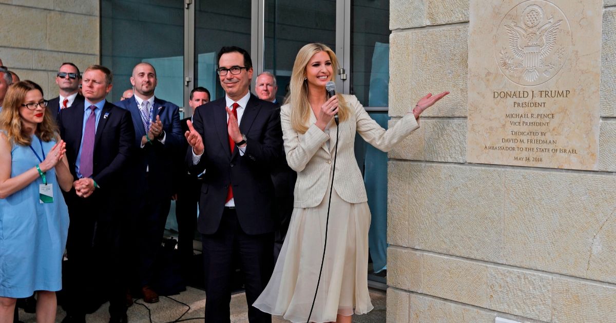 Treasury Secretary Steve Mnuchin claps as Ivanka Trump, President Donald Trump's daughter, unveils an inauguration plaque during the opening of the U.S. embassy in Jerusalem on May 14, 2018.