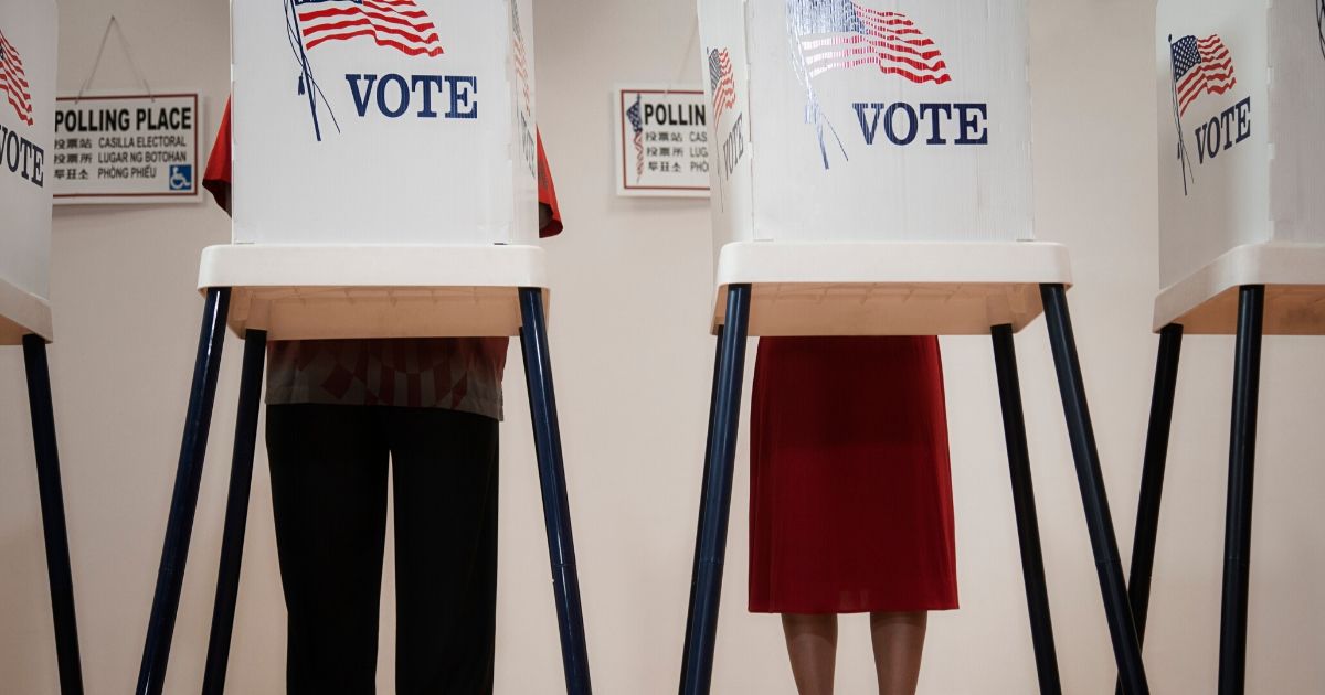 Voters cast ballots in the stock image above.