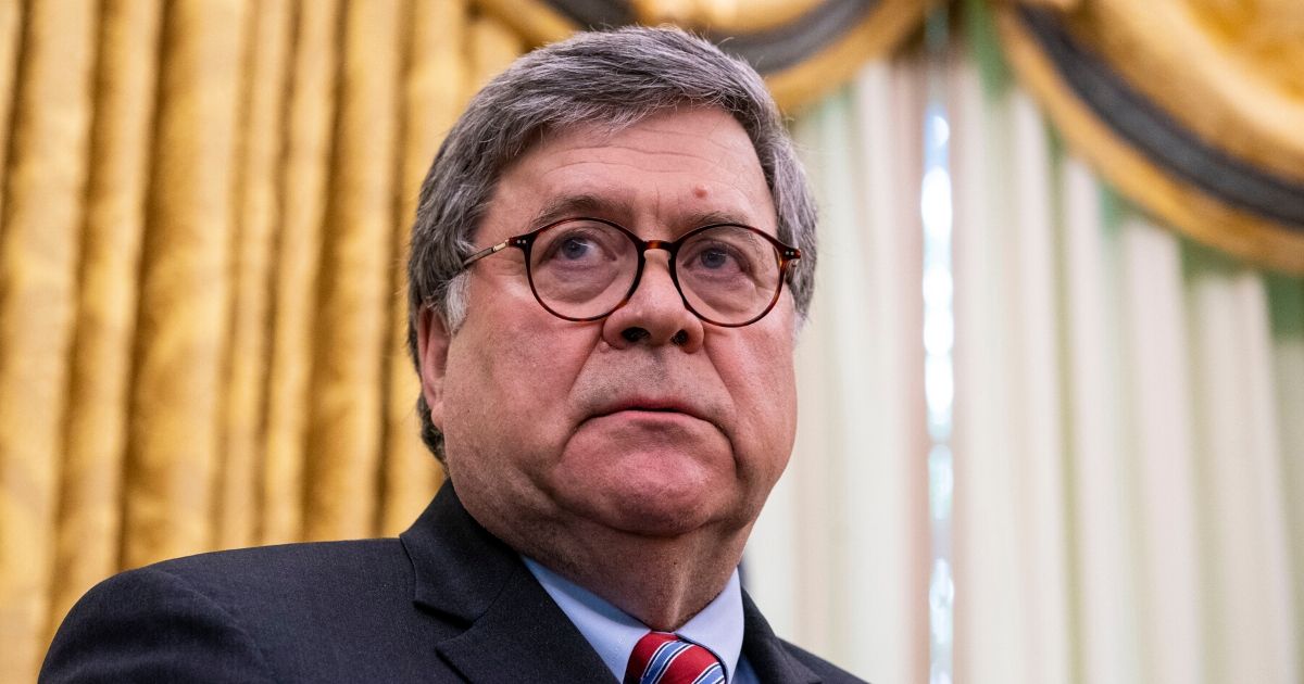 Attorney General William Barr listens as President Donald Trump speaks in the Oval Office before signing an executive order related to regulating social media on May 28, 2020, in Washington, D.C.