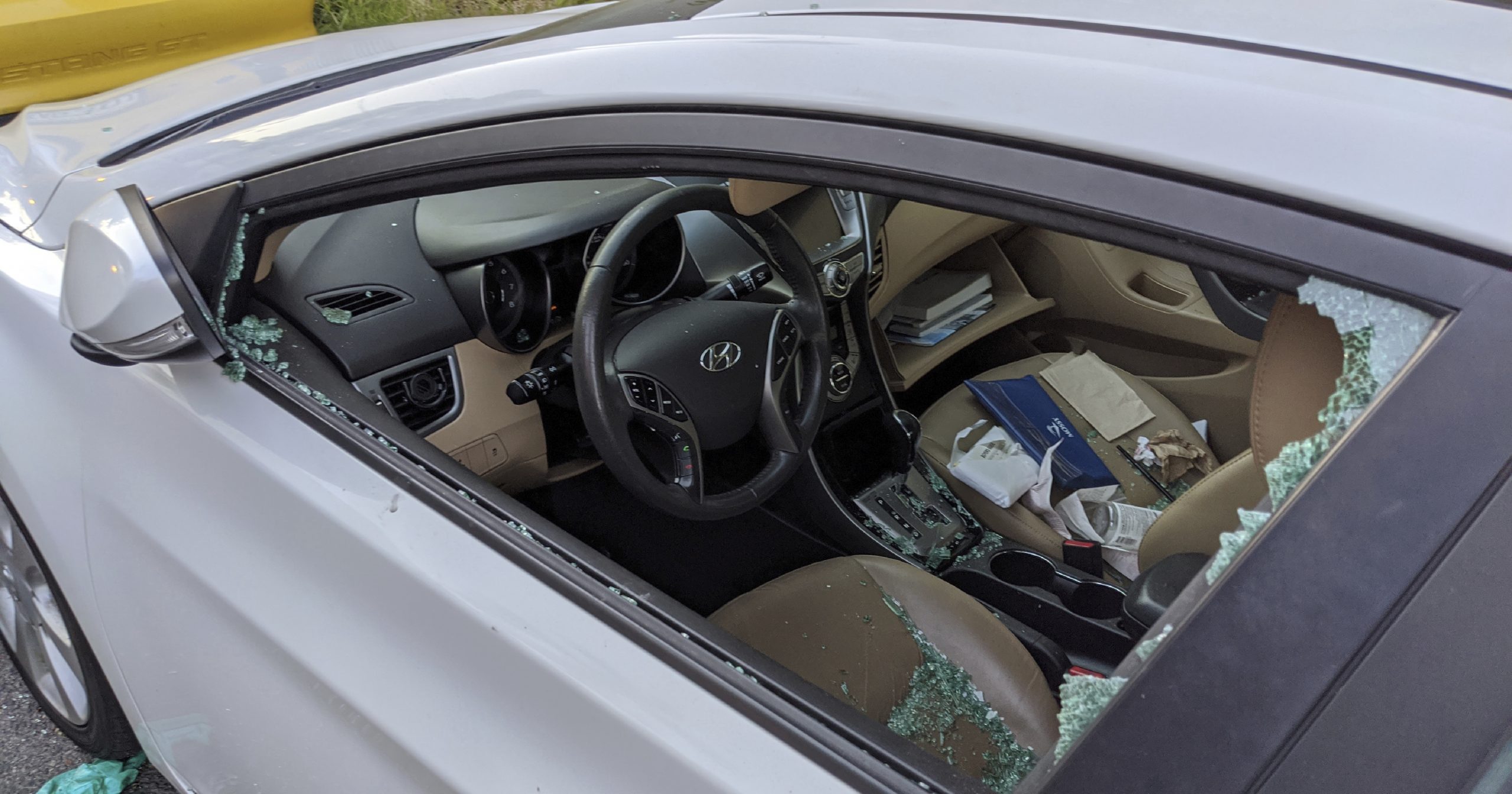 A parked car with a broken driver's side window is seen May 21, 2020, after a smash-and-grab break-in in Los Angeles.